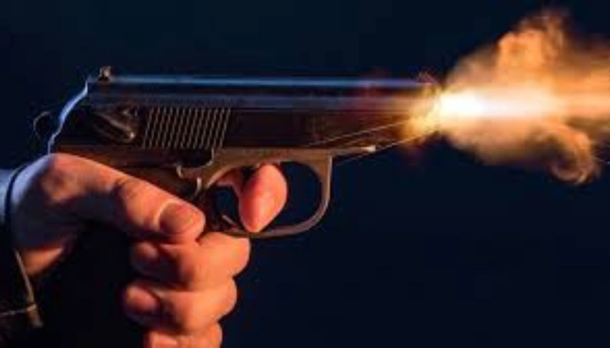 A man injured in a shooting and robbery lying on the roadside near Srinagar village in the Maner area of Patna.