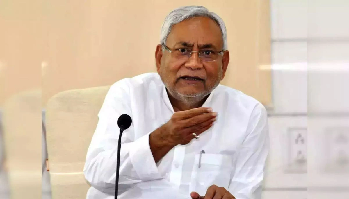 CM Nitish Kumar seated in an official meeting, appearing slightly unwell, with government officials and ministers in the background.