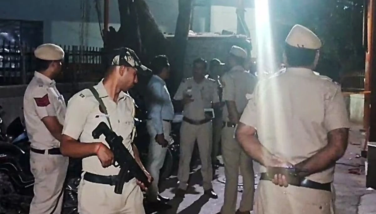 Patna crime news: Scene of a busy street in the Kankarbagh area, with police officers inspecting an Amul booth after a daylight firing incident.
