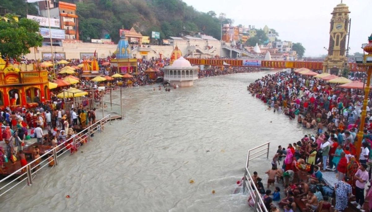 A dried-up stretch of the Ganga river in Bihar, showing large patches of exposed riverbed and reduced water levels, with surrounding areas affected by erosion and sediment build-up.