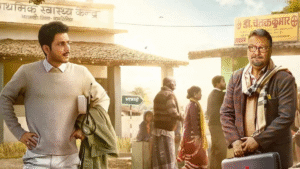 Gram Chikitsalay Web Series Review: Gram Chikitsalay Poster Featuring Amol Parashar And Vinay Pathak In A Rural Backdrop With A Broken Hospital Board And Muddy Road, Representing The Theme Of Village Healthcare Struggle